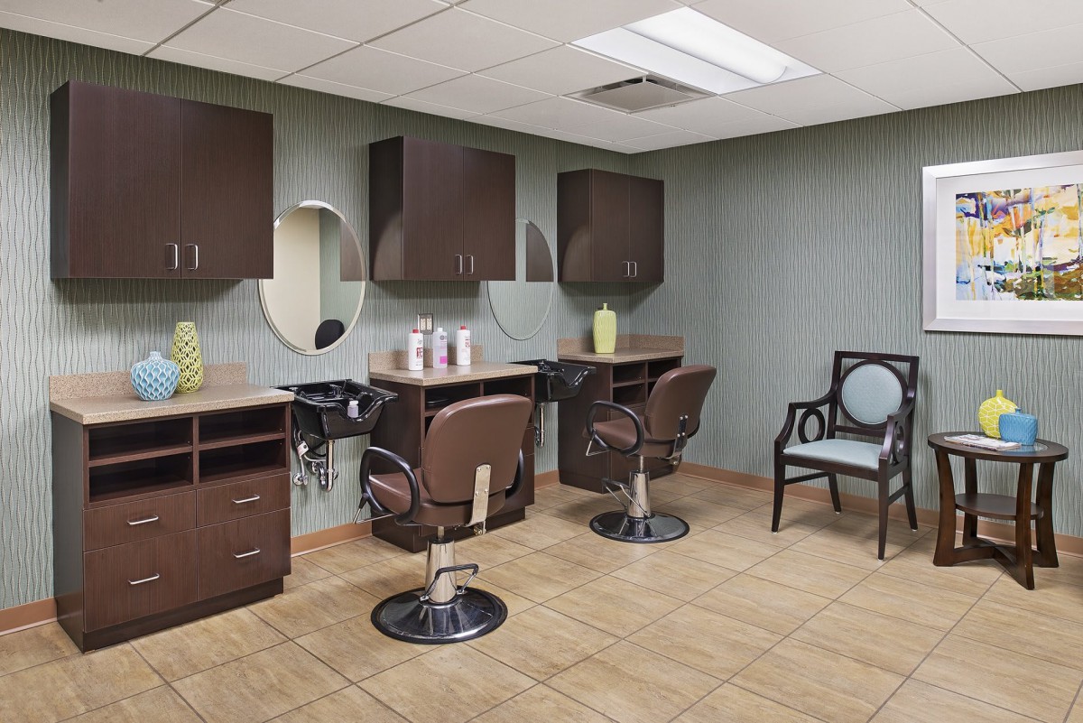 A modern hair salon interior with swivel chairs and mirrors.