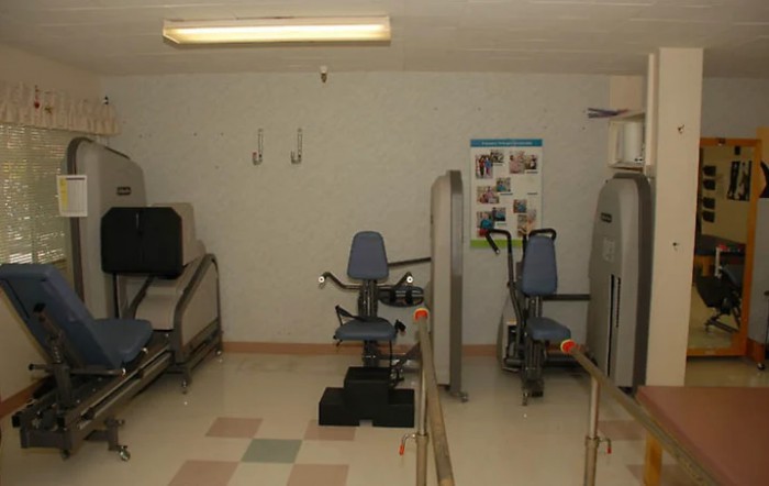 An indoor gym with various exercise machines.