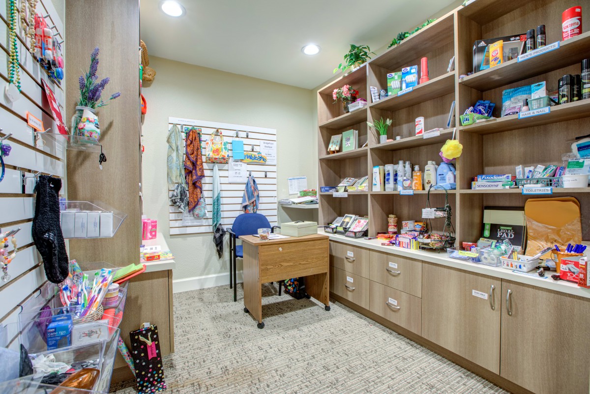 A well-organized laundry room with shelves filled with household items and cleaning supplies.