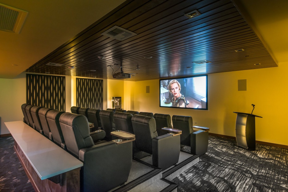 A modern home theater with comfortable seating and a large screen.