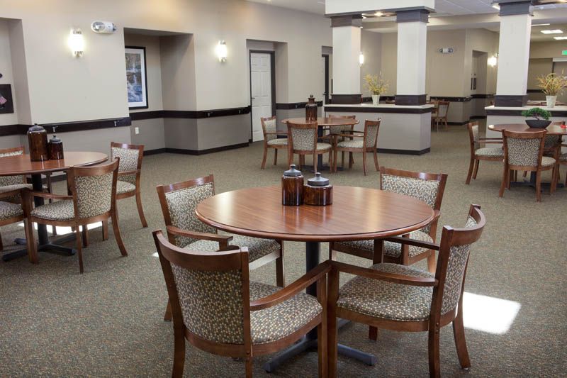 A spacious dining area with several tables and chairs arranged for gatherings.