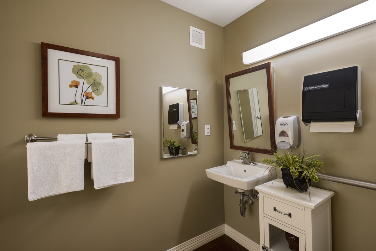 A well-organized bathroom with a sink, mirror, and decor.