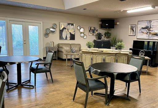 A cozy lounge area featuring modern furniture and decorative elements.