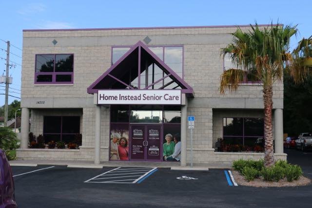 The exterior of a senior care facility with accessible parking spaces.