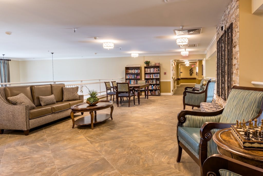 A cozy living room with comfortable seating and bookshelves.