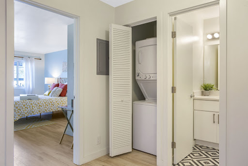 A compact laundry area featuring a stacked washer and dryer, seamlessly integrated into the apartment's design.