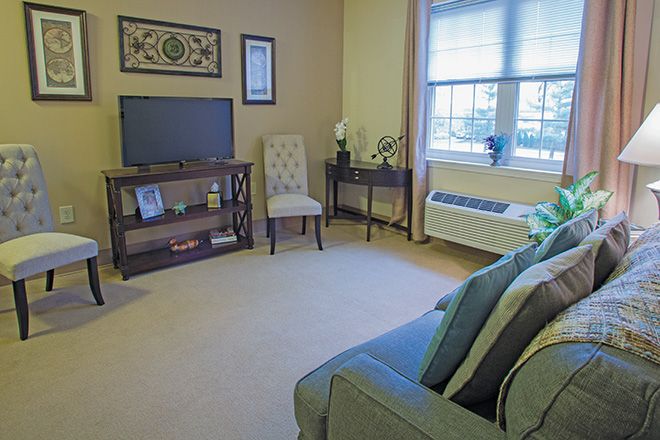 A cozy living room with a television, sofa, and decorative elements.