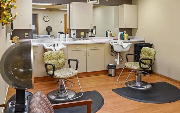 Interior view of a hair salon with chairs, mirrors, and sinks.