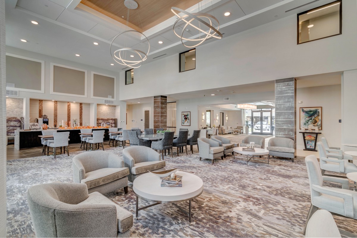 A luxurious and modern lobby featuring comfortable seating, elegant lighting fixtures, and stylish interior design.