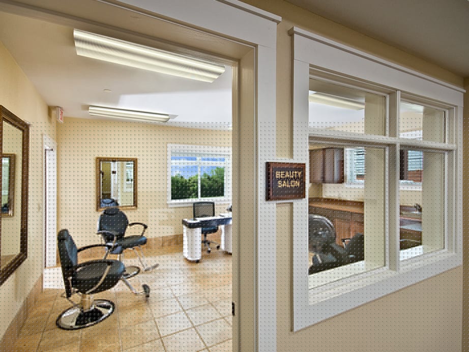 Interior view of a beauty salon with chairs and mirrors.