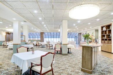 An elegant restaurant interior with neatly arranged dining tables and chairs.
