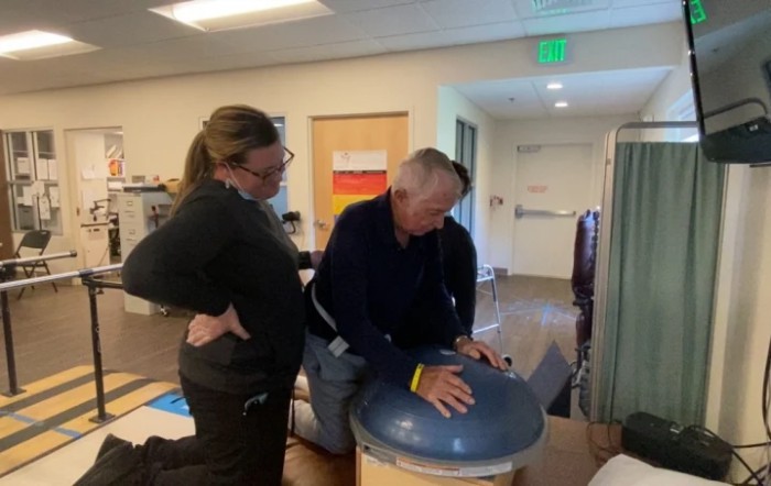 A person receiving guidance during a physical therapy session.