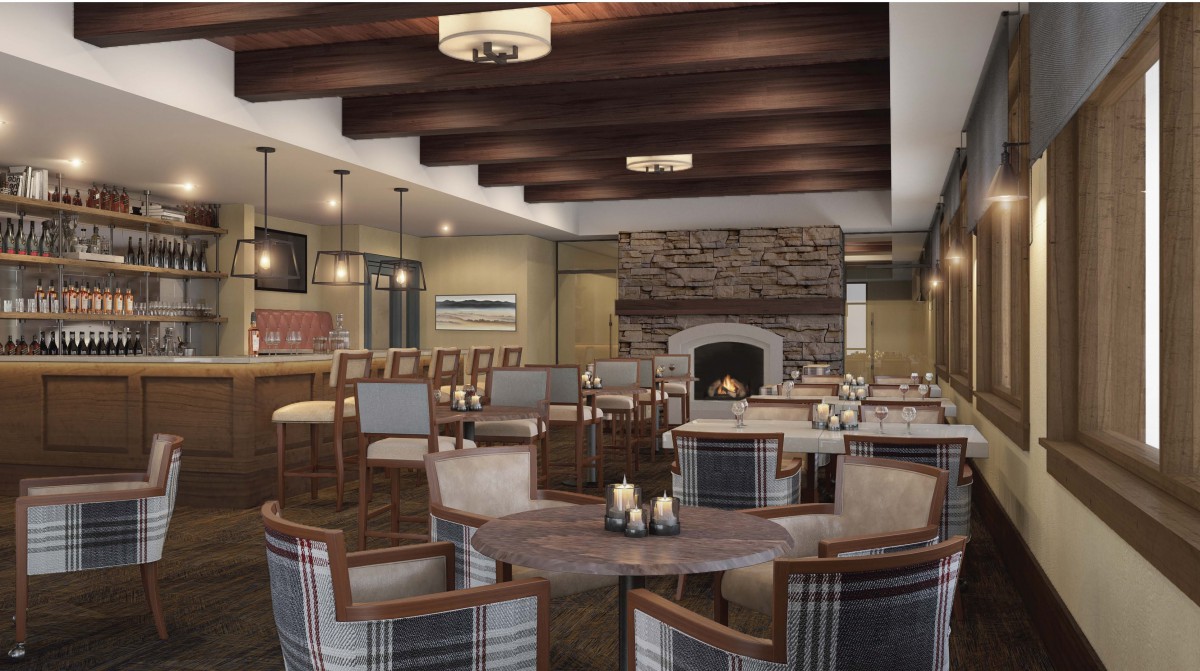 A cozy lounge area with a fireplace, featuring comfortable seating and wooden beam ceilings.
