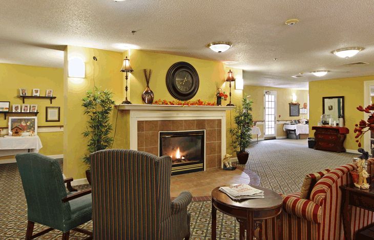 A cozy living room with a fireplace and comfortable seating.