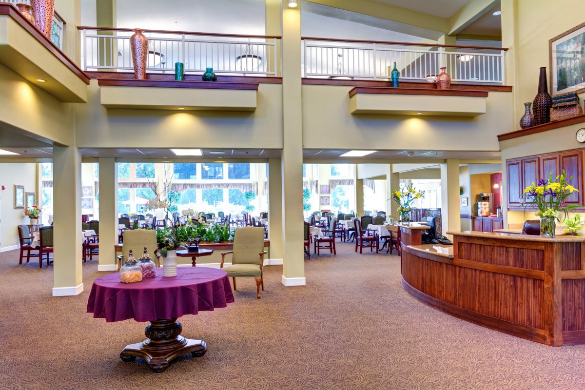 A spacious and well-decorated lobby with a reception desk and seating areas.