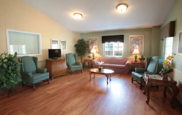 A cozy living room with comfortable seating, wooden floors, and warm lighting.