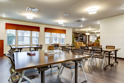 A bright and modern dining area featuring tables and chairs, perfect for communal gatherings.