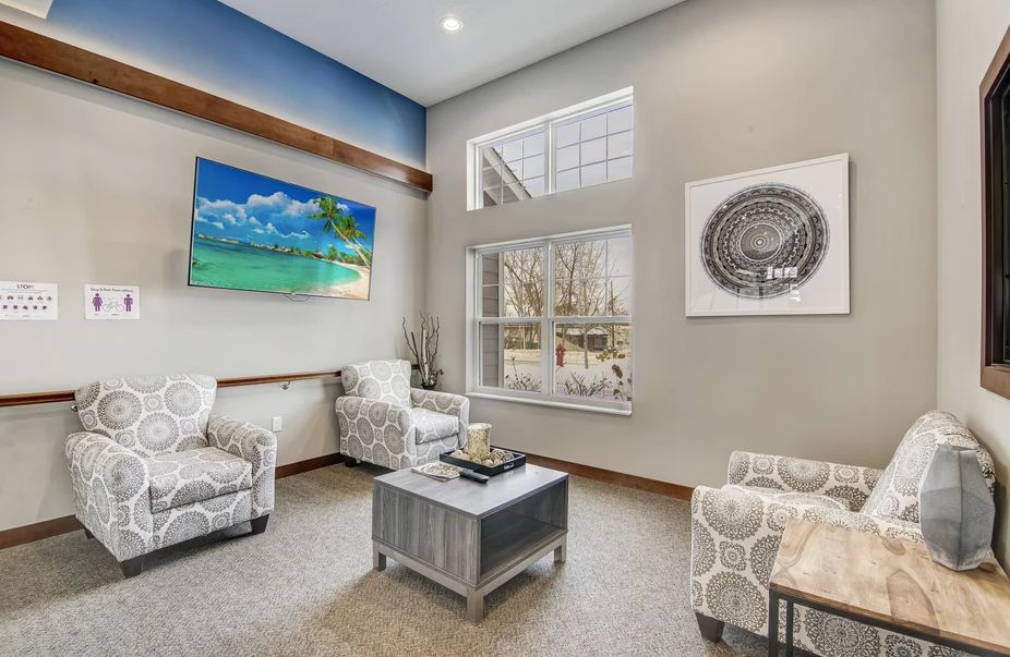 A modern living room with comfortable seating and decorative artwork.