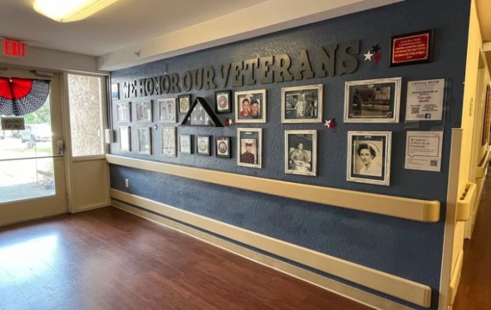 A wall display dedicated to honoring veterans, featuring photographs and memorabilia.