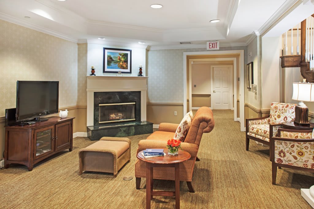 A cozy living room with a fireplace and comfortable seating.