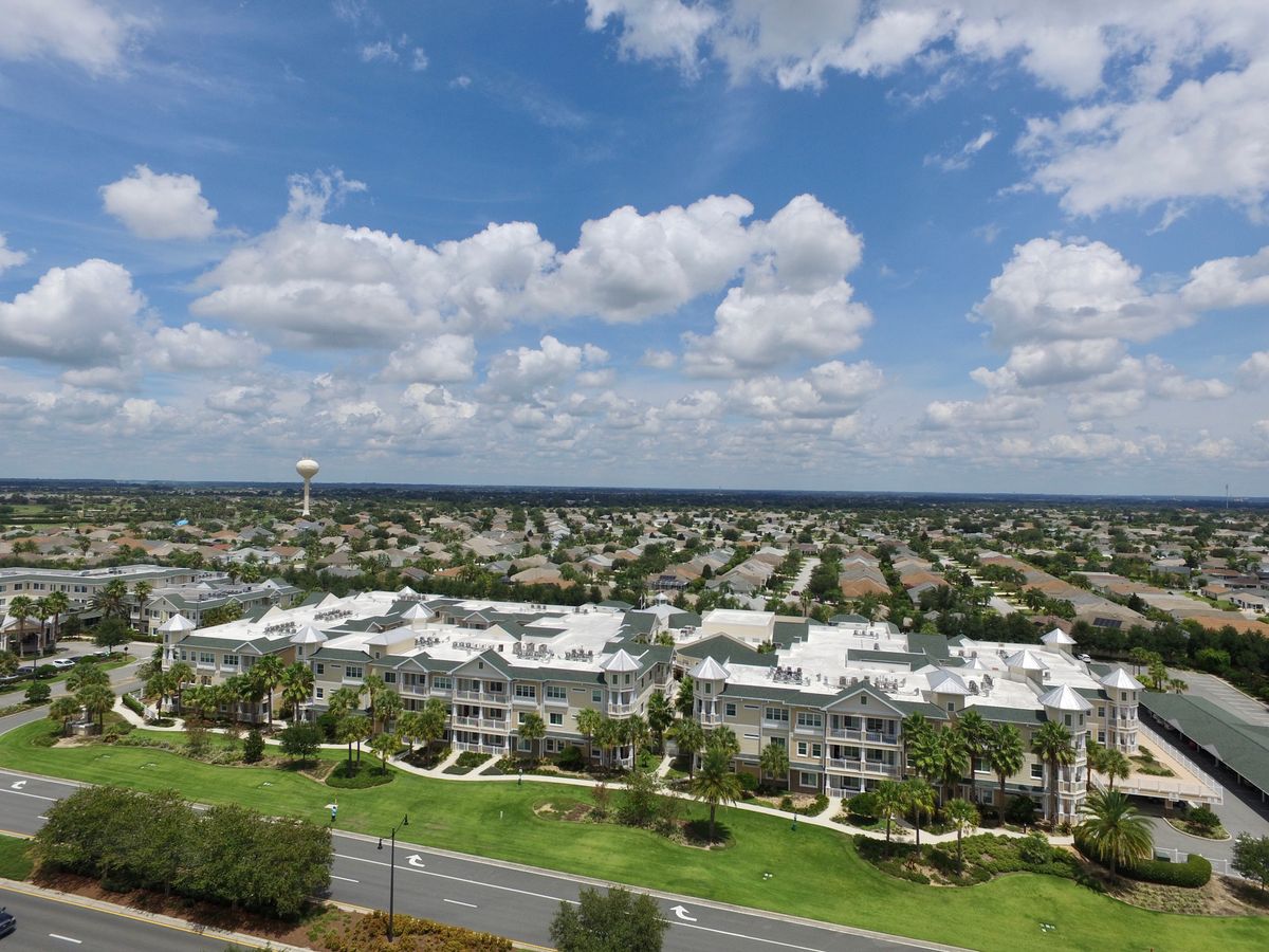 Aerial view of a suburban residential area under a partly cloudy sky.