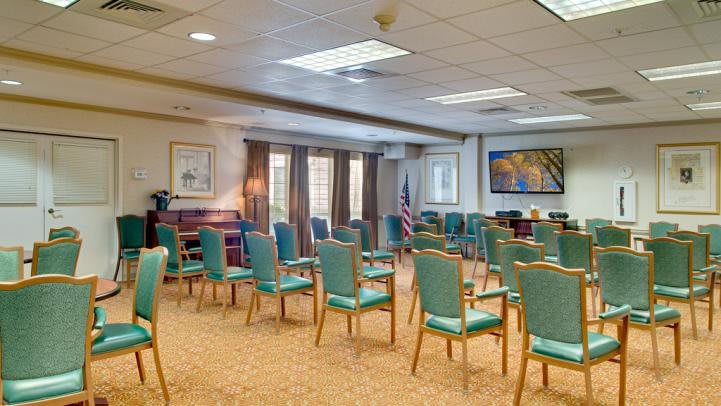 An empty conference room arranged with chairs in rows, ready for a meeting or event.