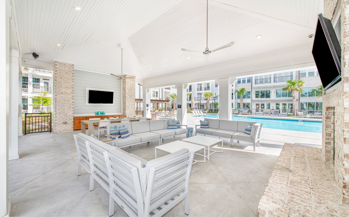 Modern poolside lounge area with comfortable seating and open views.