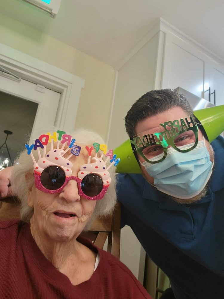 Two people celebrating a birthday with colorful and funny glasses.
