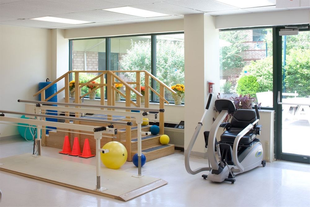 A rehabilitation center equipped with various exercise machines and tools for physical therapy.