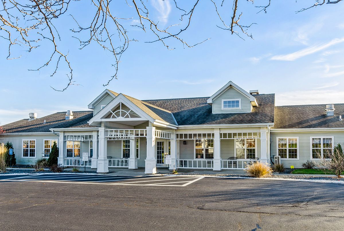A charming residential building with a welcoming front porch and picturesque architecture.