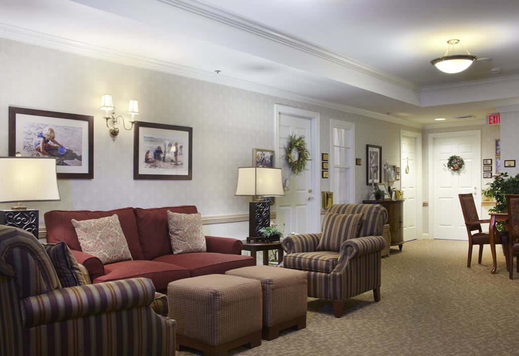 A cozy living room with a sofa, armchair, and decorative elements.