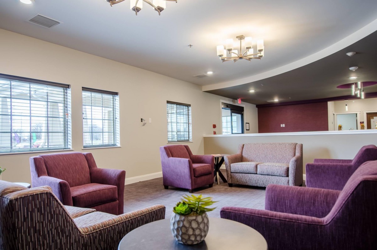 A modern living room with comfortable seating and decorative lighting.