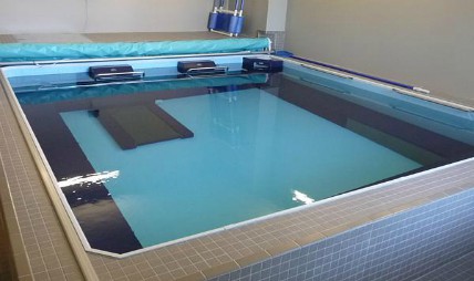 An indoor therapy pool designed for aquatic rehabilitation and exercise.