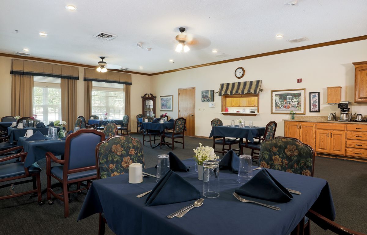A neatly arranged dining room with tables set for a meal.