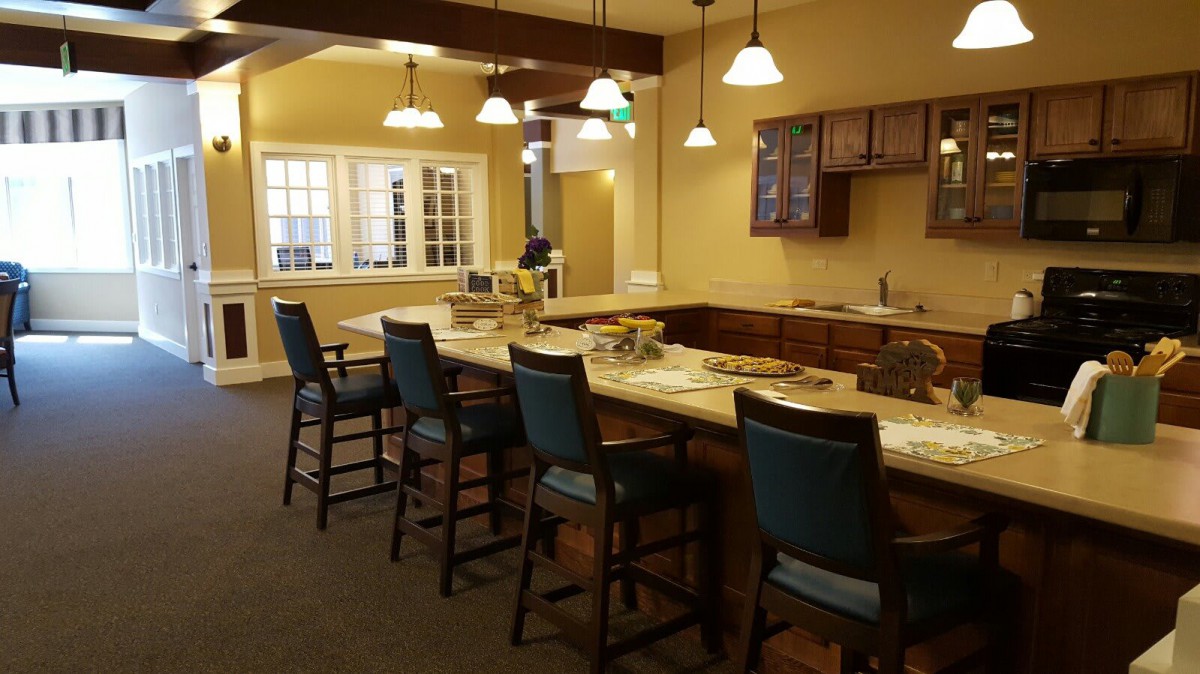 A cozy kitchen interior with a high counter and bar stools.