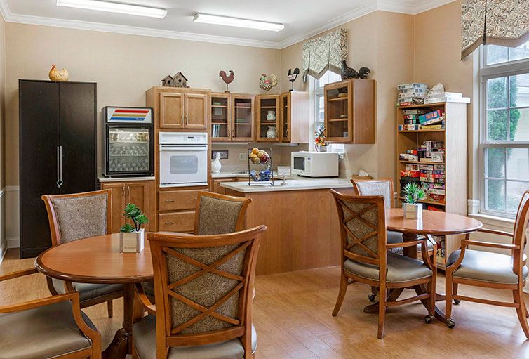 A cozy kitchen and dining area with wooden cabinets and comfortable seating.