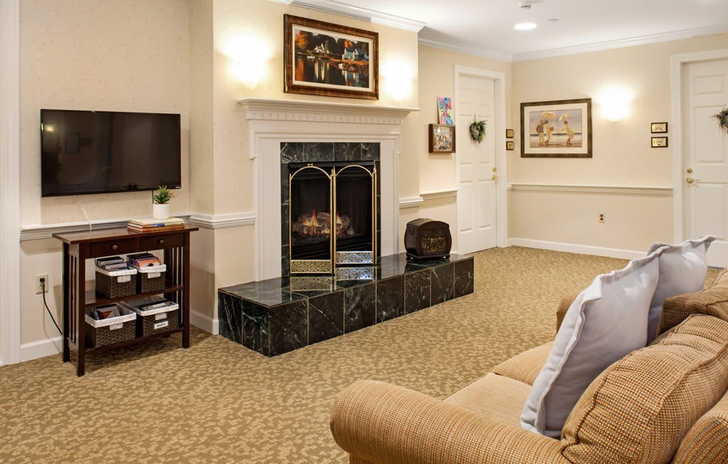 A cozy living room with a fireplace, television, and comfortable seating.