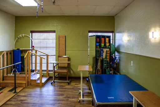 A well-equipped physical therapy room featuring wooden steps and exercise equipment for rehabilitation.