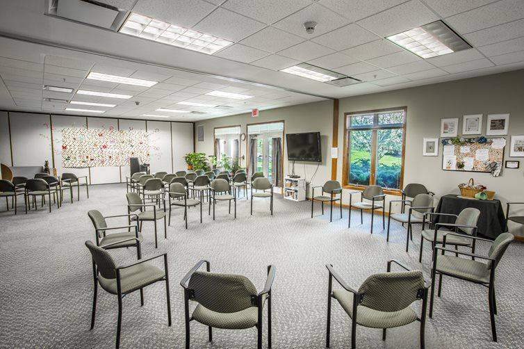 An empty conference room set up with chairs arranged in a circle.