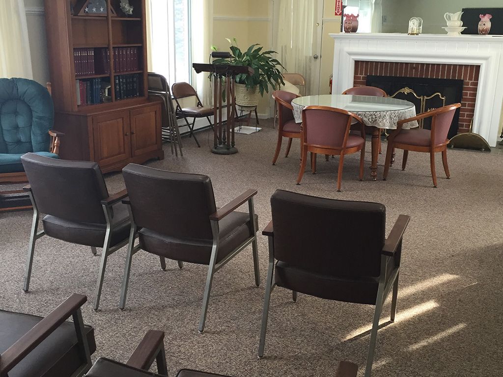 An empty waiting room with arranged chairs and a small table.