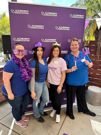 A joyful gathering celebrating together, adorned with fun purple accessories!