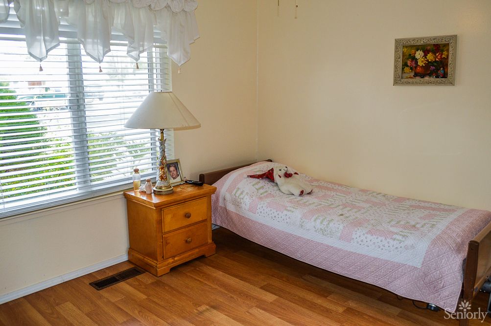 A small, cozy bedroom with a single bed and nightstand.