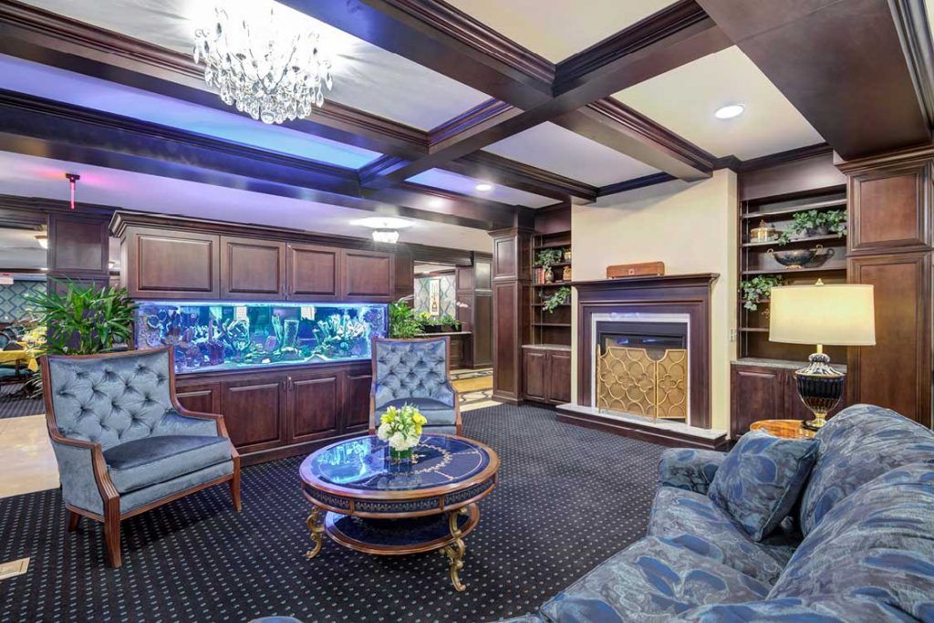 Luxurious living room with a large aquarium and elegant wooden interior.