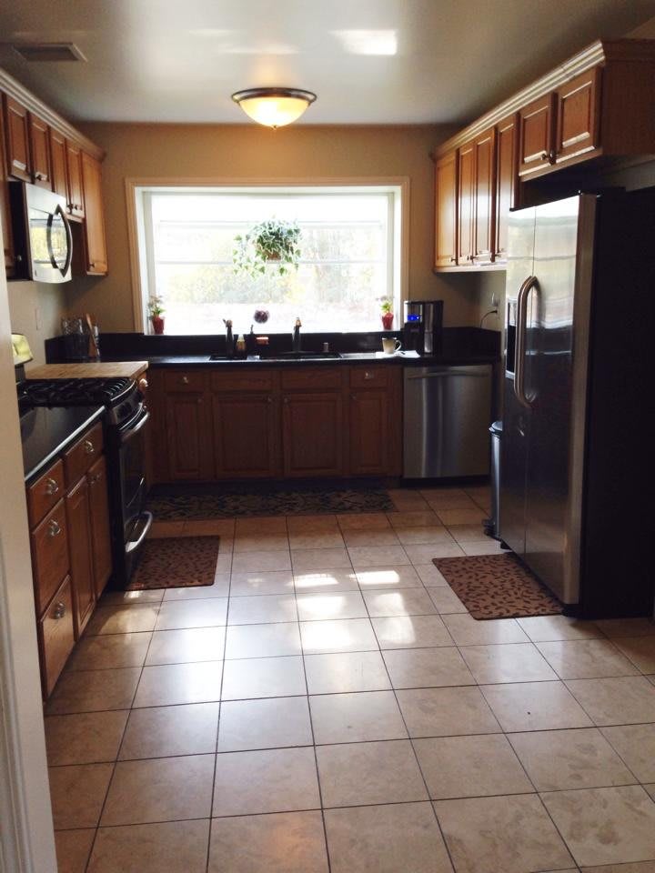 A modern kitchen with wooden cabinets and stainless steel appliances.