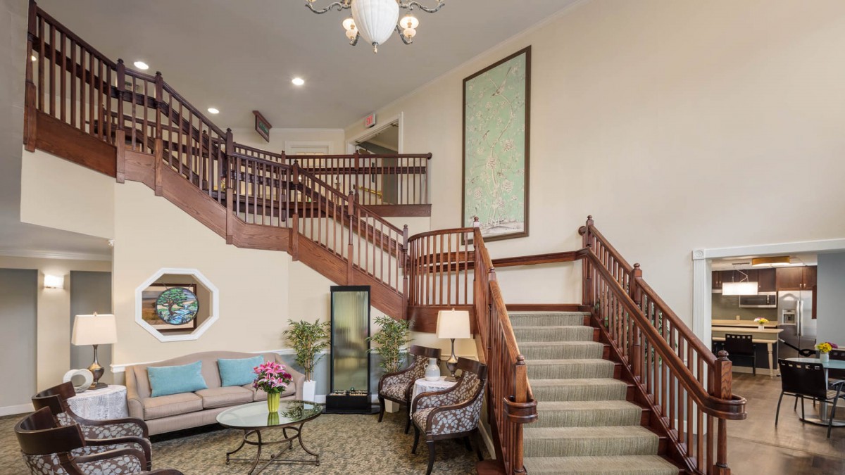 A welcoming lobby with a grand staircase and cozy seating area.