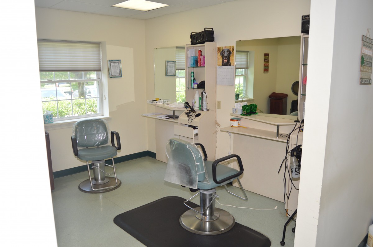 A neat and organized beauty salon with styling chairs and mirrors.