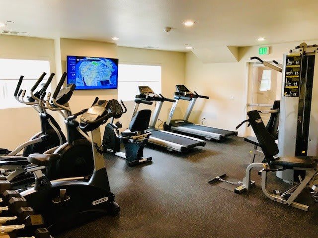 A well-equipped indoor gym with treadmills and stationary bikes.