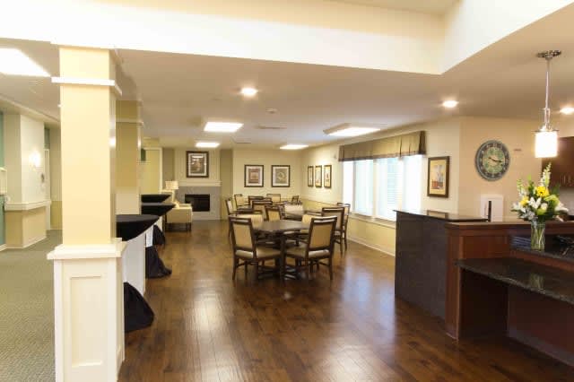 A bright dining area with wooden flooring and elegant furniture.