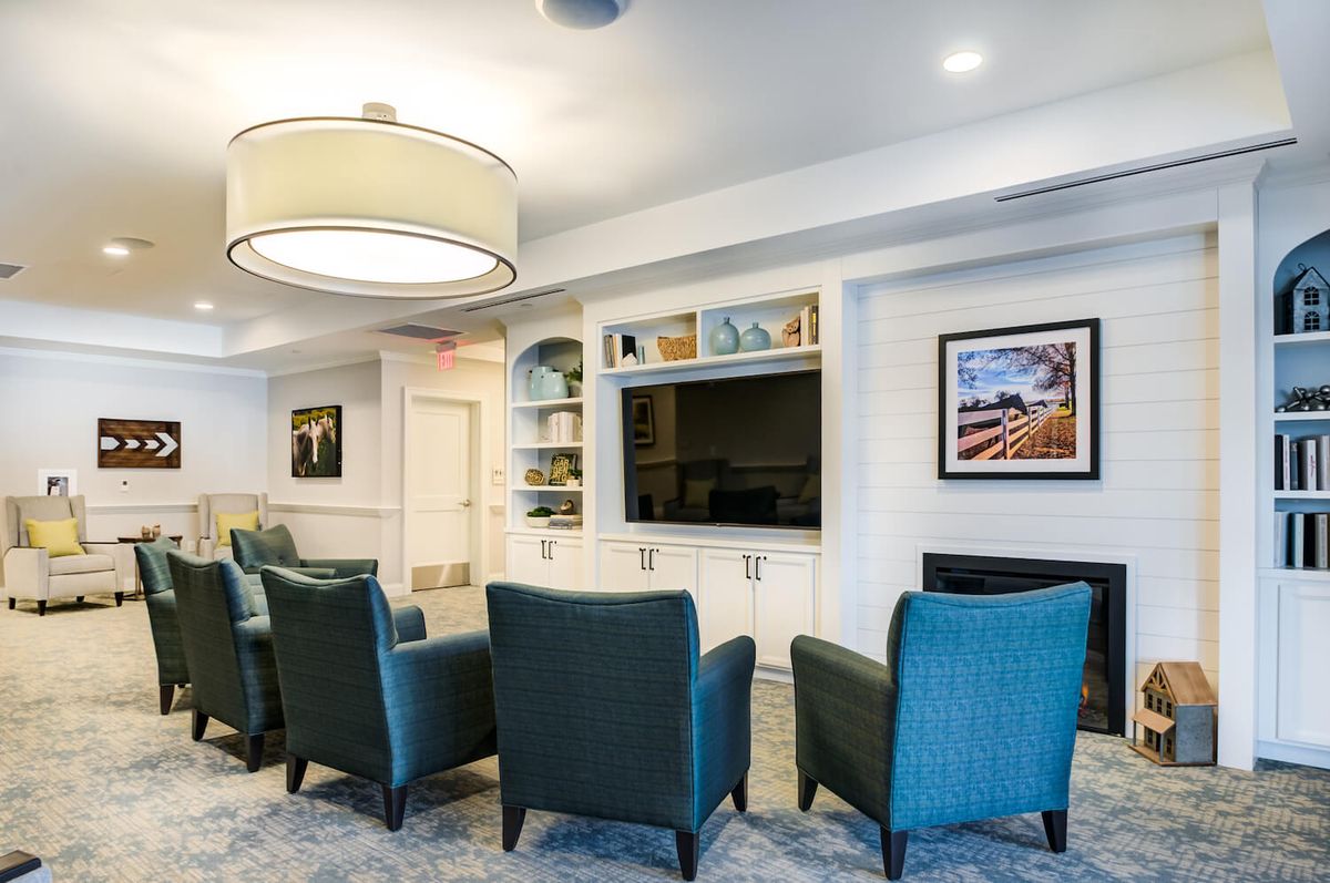 A modern living room with a cozy seating arrangement and a large television.