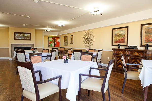 A well-decorated dining room with neatly arranged tables and chairs.